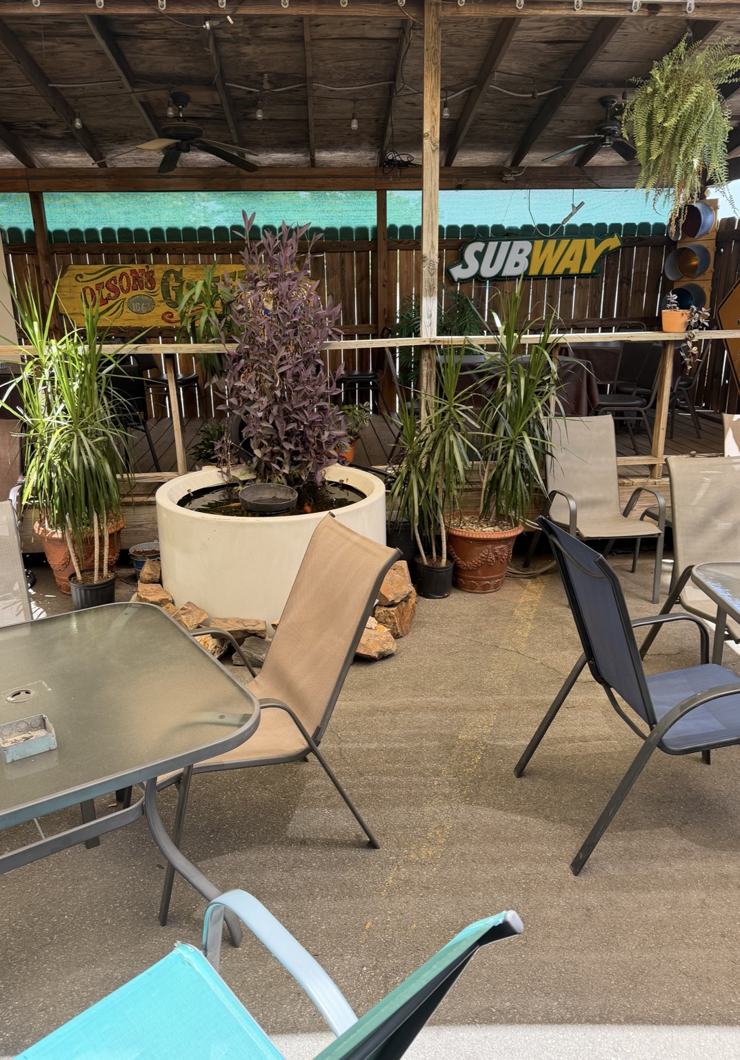 CHAPS patio seating around a fountain and greenery